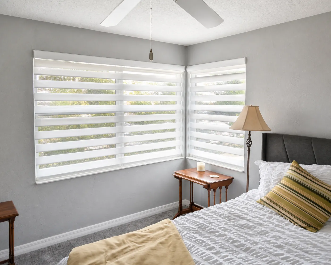 Custom white zebra shades providing filtered light and privacy in a St. Augustine bedroom