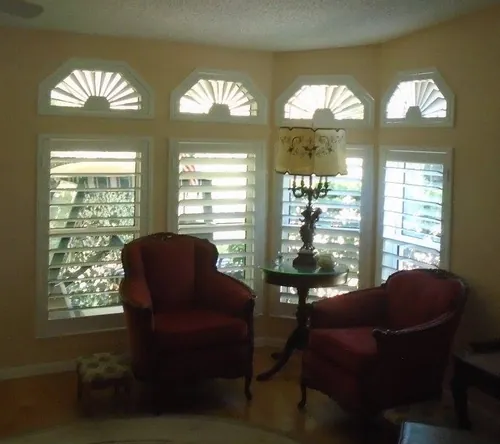 Custom shutters fitted to fan-top and specialty-shaped windows in a St. Augustine home