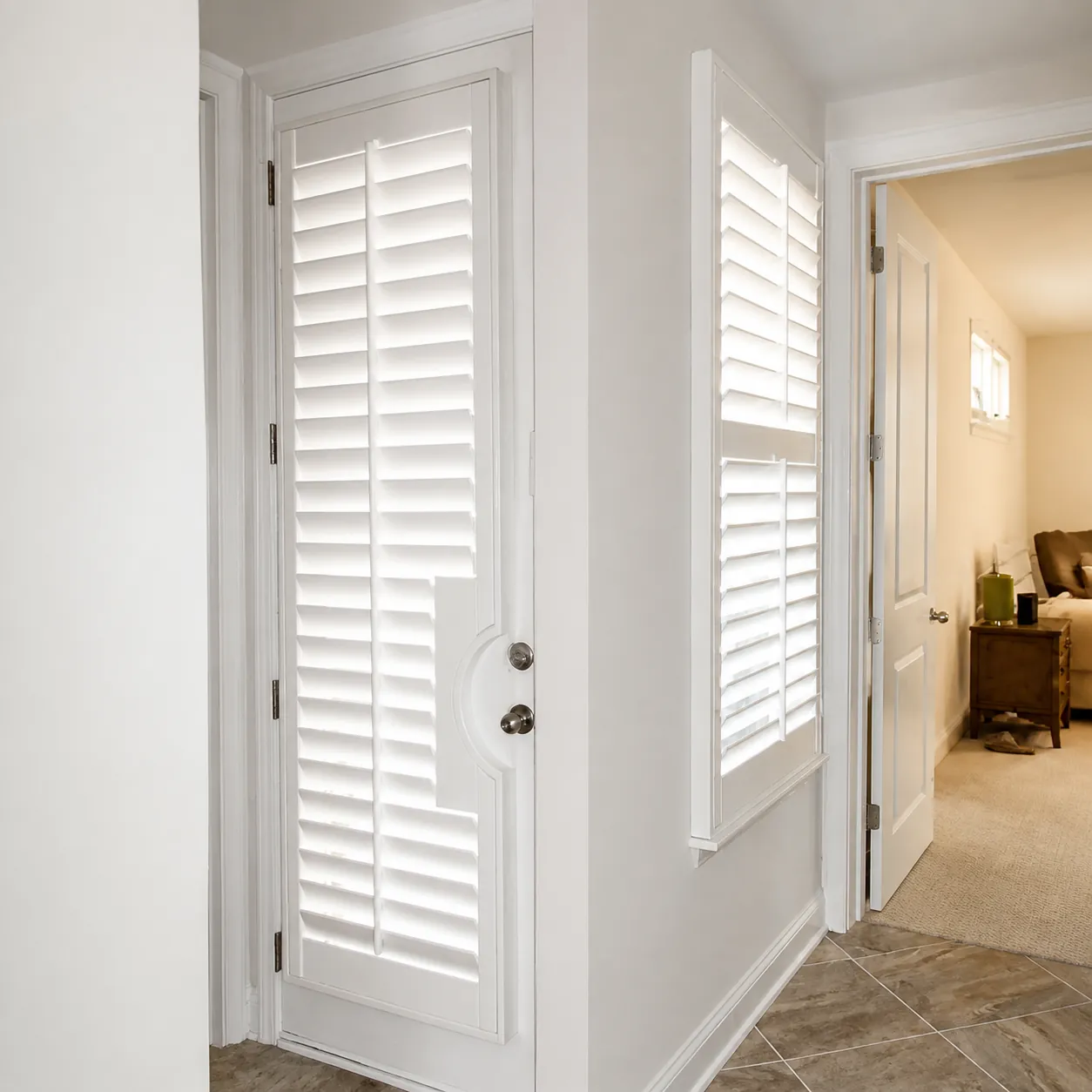 Custom door and sidelight shutters in St. Augustine Custom white door and sidelight shutters fitted for privacy in a St. Augustine home