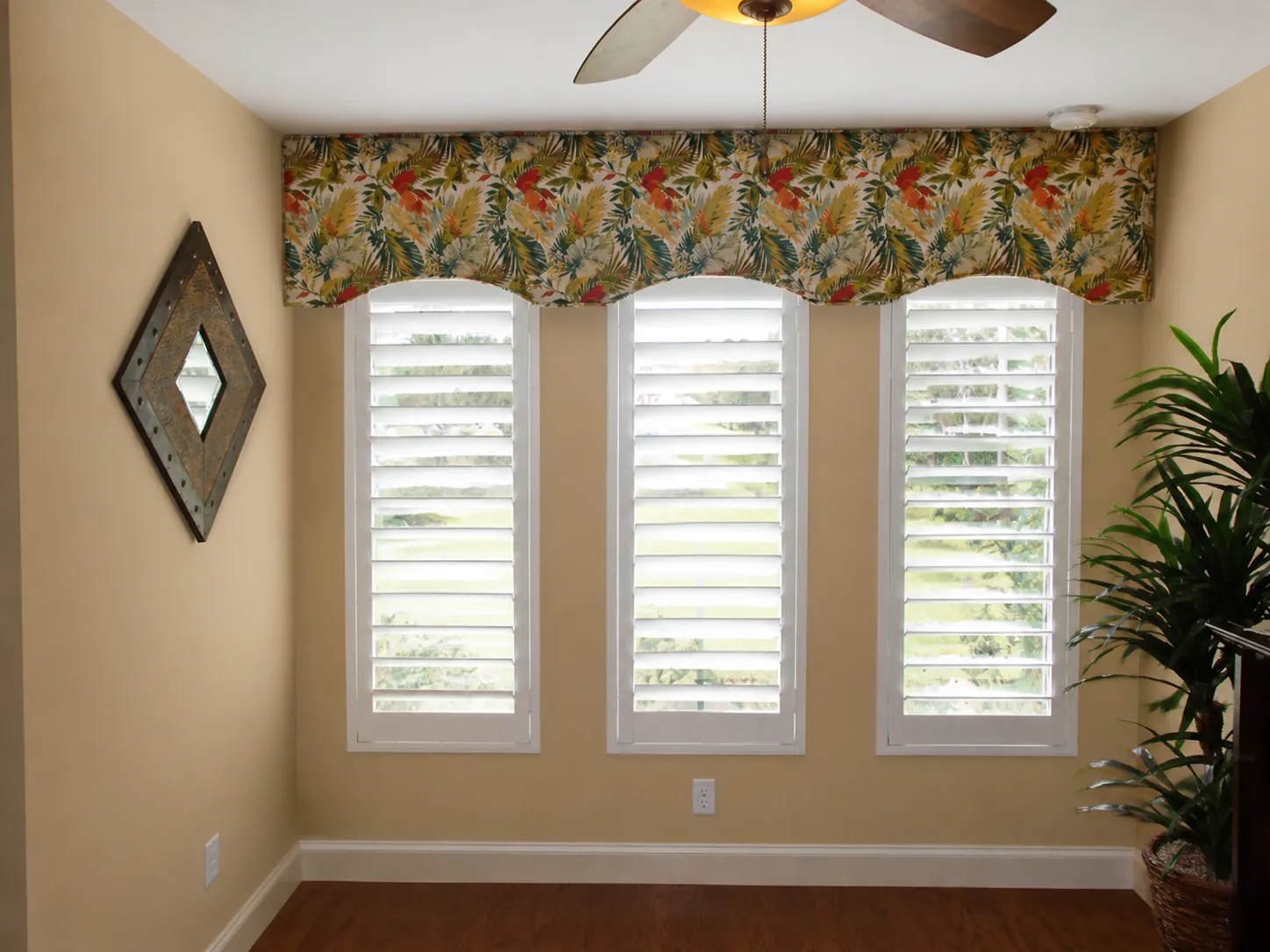 Three custom white plantation shutters fitted to narrow windows in a St. Augustine home