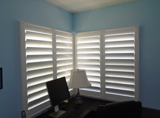 Corner window plantation shutters in a St. Augustine home office