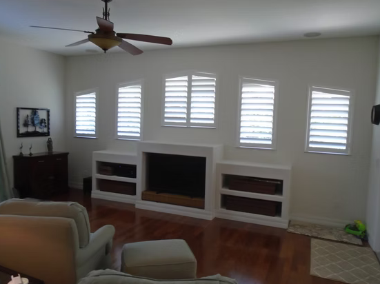 Five custom plantation shutters surrounding a fireplace in a St. Augustine home