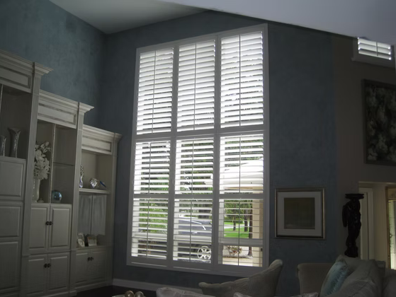 Two-story plantation shutter installation in a St. Augustine living room