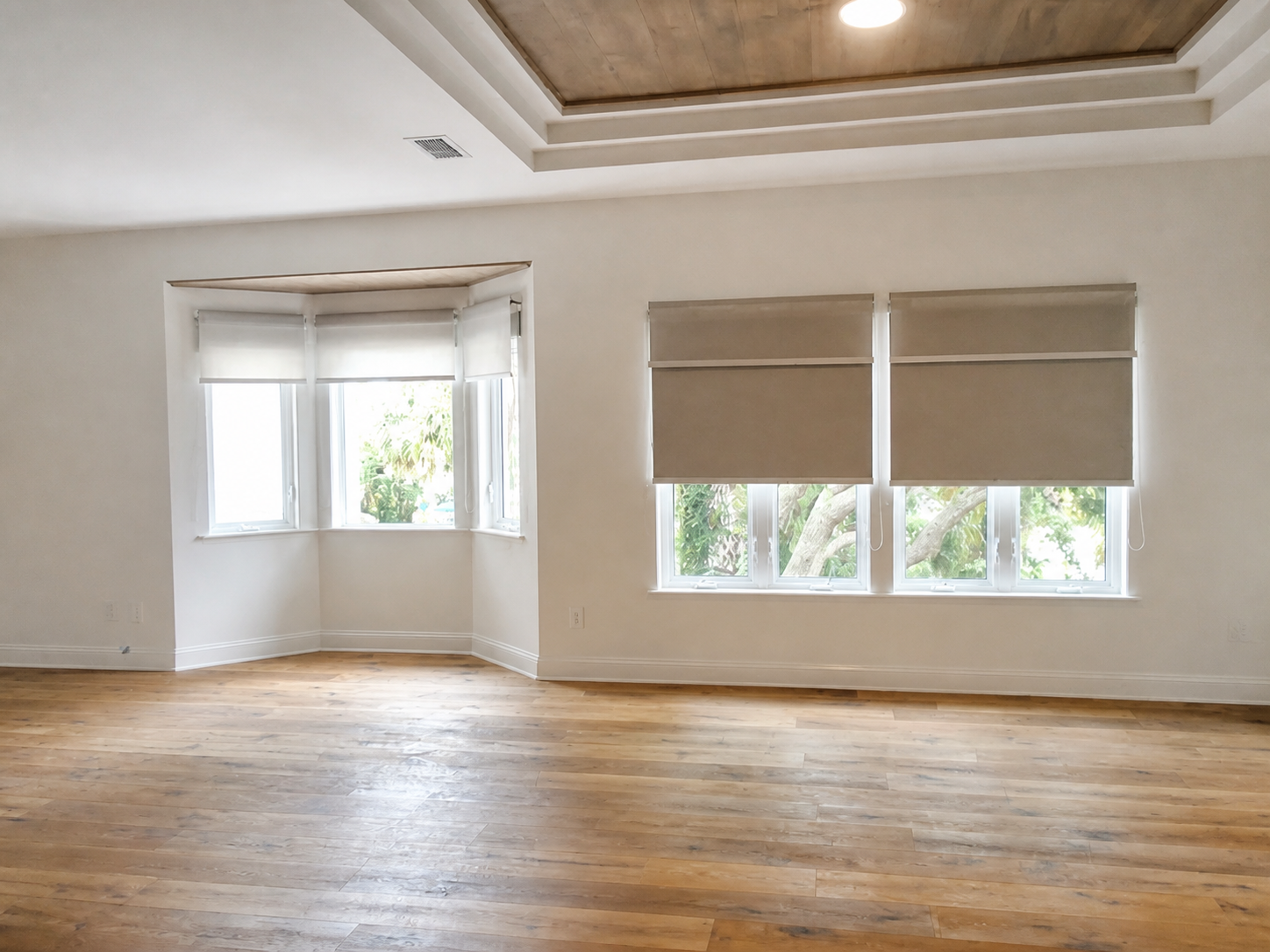 Custom roller shades installed across bay and rectangular windows in a St. Augustine home